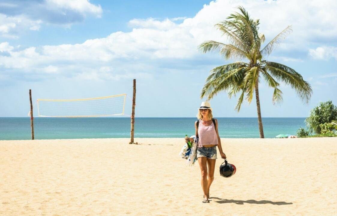 Young woman traveler walking on the beach at island hopping in Phuket